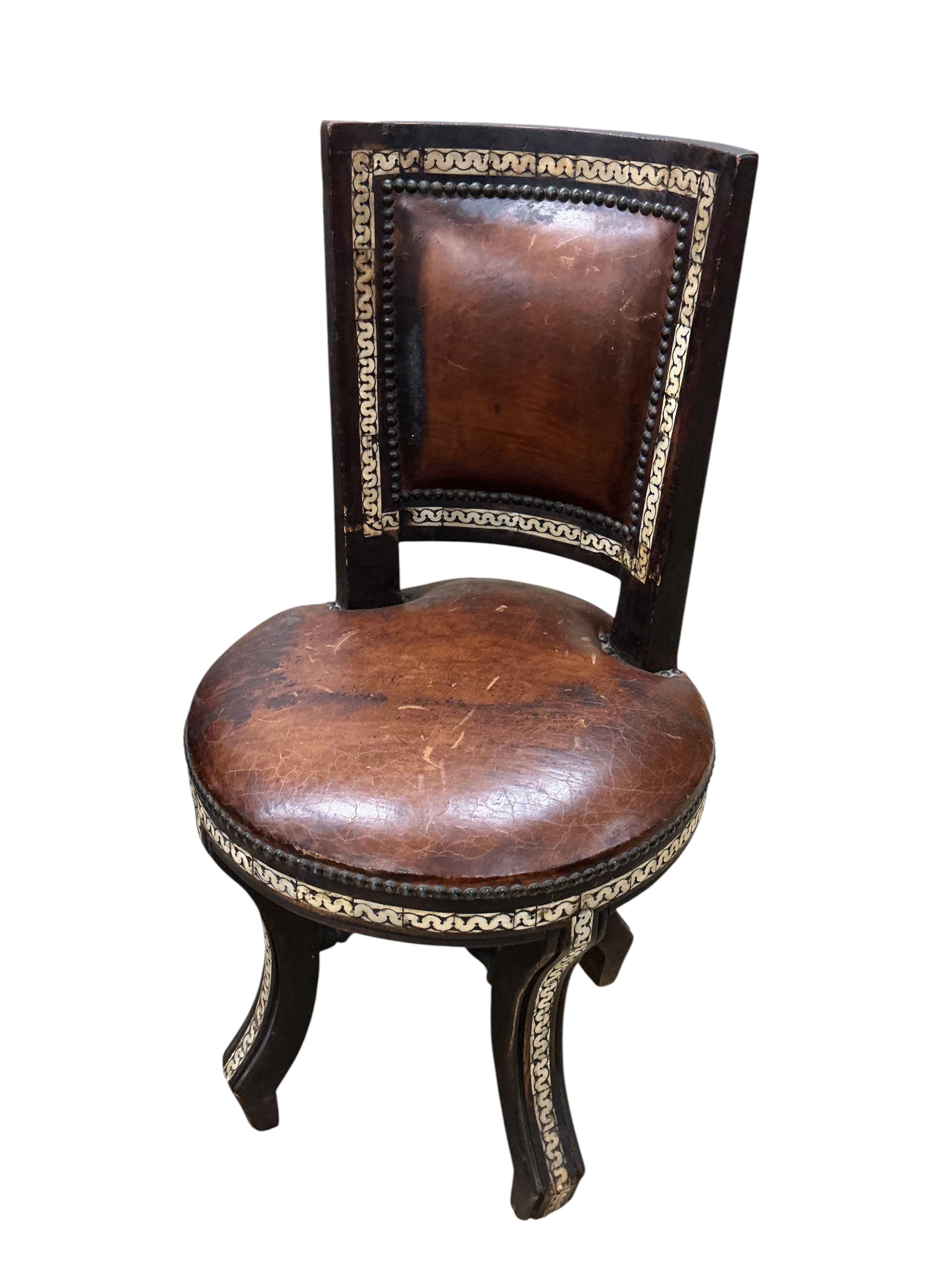 A Moroccan circular studded cedar glass top bistro table, diameter 80cm, height 76cm together with two matching chairs